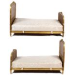 A pair of giltwood bergere bedsteads, the floral decoration to the centres, 130cm high x 111cm wide,