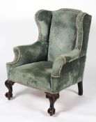 A George II style wing back armchair, 19th century,