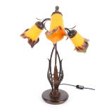 An Art Nouveau style three light lamp,