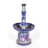 A Chinese enamel pricket candlestick with large drip pan above a bell shaped base,