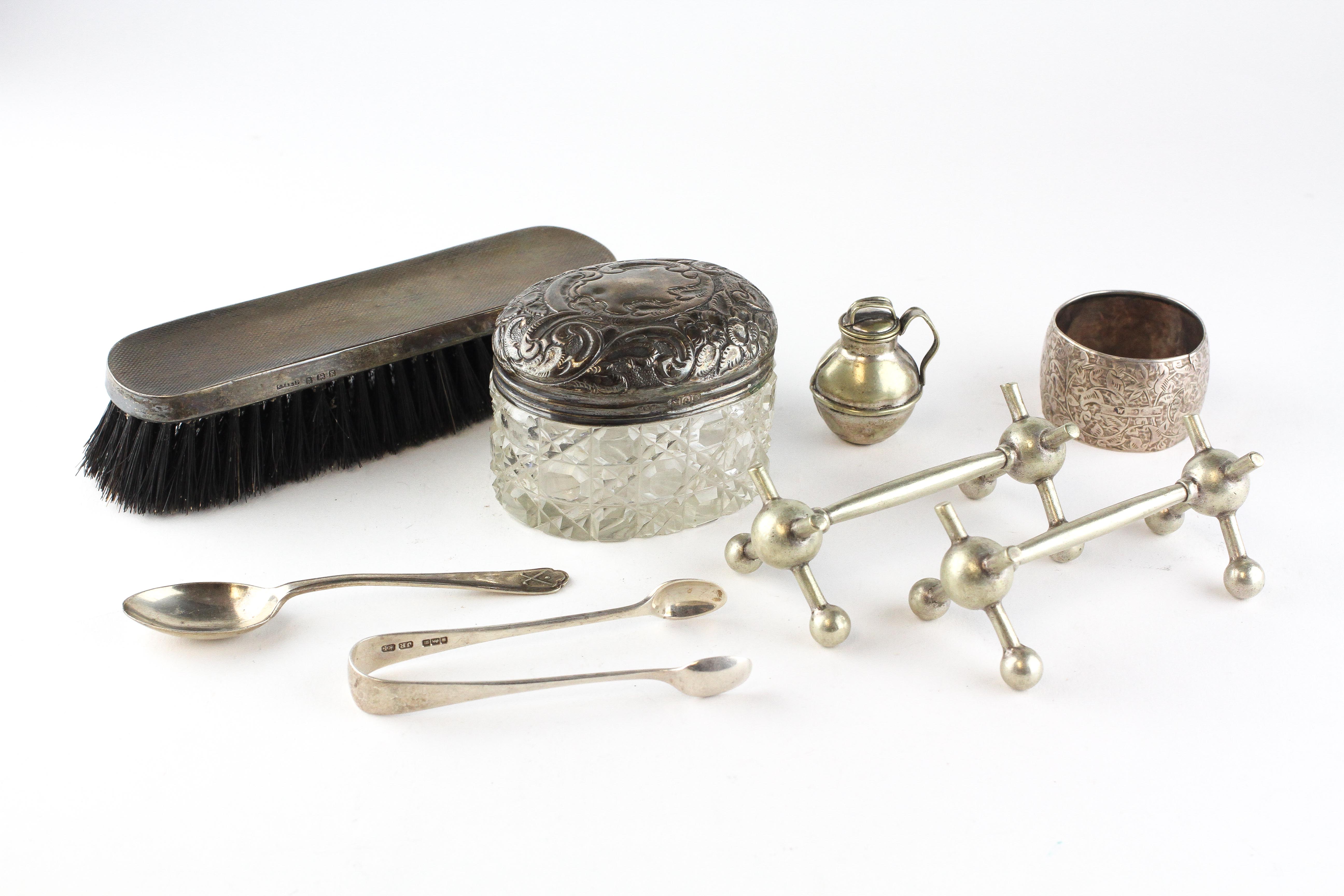 An assortment of silver and silver plated items, to include a set of sugar tongs, spoon,