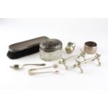 An assortment of silver and silver plated items, to include a set of sugar tongs, spoon,