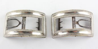 A pair of large ornate Georgian shoe buckles of rectangular form,