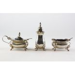 A three piece silver cruet set, comprising lidded mustard, open salt and a pepper pot,