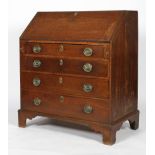 A Georgian oak bureau, the fall front enclosing a fitted interior above four long drawers,