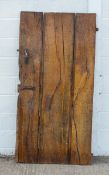 A planked elm door, possibly 17th century, with iron furniture,