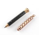 Two yellow metal propelling pencils, the first of spiral form,