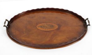 A Georgian mahogany tray, of oval form inlaid with a shell motif inside a wavy gallery,