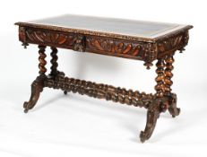 A Victorian carved oak desk, the top inset with tooled blue leather, with gadrooned, frieze,