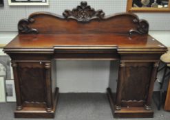 A Victorian mahogany chiffonier, the top with carved foliate scrolling,