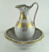 An early 20th century gilt decorated wash jug and bowl,