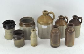 A collection of various stoneware pots and containers, including one made in Bristol,