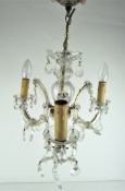 A glass three branch chandelier,