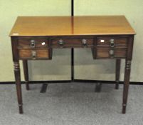 An early 20th century mahogany desk with lion shaped handles,
