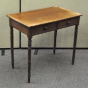 A two drawer mahogany hall table raised on turned supports,
