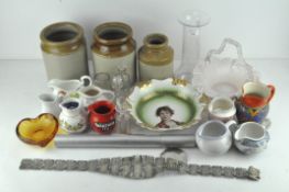 A collection of assorted pouring milk jugs and other items,