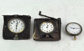 Three early travelling clocks, two in part leather cases,