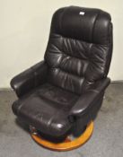 A brown leather revolving armchair,