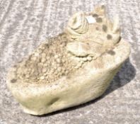 A reconstituted stone pig in bath sculpture,