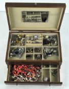 A collection of assorted costume jewellery in a fitted jewellery box