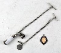Two silver Albert chains with T-bars, one with attached seal and a white metal cheroot holder,