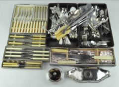 A collection of silver plated flatware, including butter knives, spoons and much more,