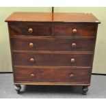 A Victorian mahogany chest of drawers, raised on turned supports, two short over three long drawers,