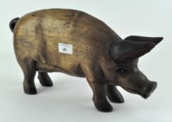 A carved hard wood pig,