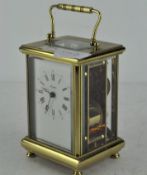 A brass cased Angelus carriage clock, the enamel dial with Roman numerals denoting hours,