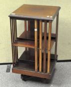 A 20th century mahogany revolving book case,