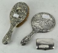 A silver backed hair brush and a hand mirror,