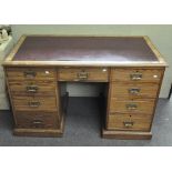 An early 20th century pine twin pedestal desk,