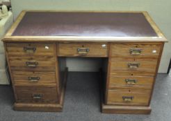 An early 20th century pine twin pedestal desk,