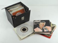 A collection of 45 rpm vinyl single records, including Elvis Presley, Bee Gees (signed?) and others,