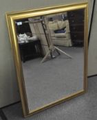 A large gilt framed bevelled edged mirror,