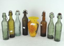 A selection of various vintage glass bottles, including Biere and Limonade,