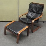 A vintage black leather cantilever chair with footrest,