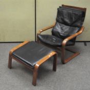 A vintage black leather cantilever chair with footrest,