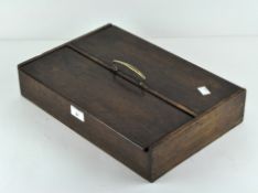 A twin compartment oak cutlery box with brass carry handle. Length 39.5cm.