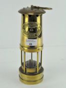 A Welsh miners lamp, the plaque inscribed E Thomas and Williams Ltd No 63476. H 26cm.