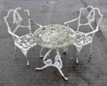 A white painted cast iron patio table and two chairs