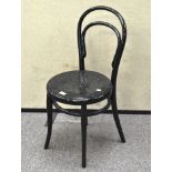 A black painted bedside chair, on turned supports,