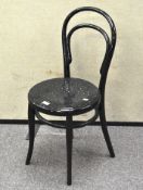 A black painted bedside chair, on turned supports,