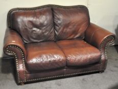 A 20th century Leather sofa two seat sofa, adorned with metal stud decoration,
