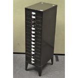 A tall thin metal filing cabinet, comprising fifteen drawers,
