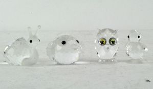Four Swarovski figures, including a Snail, Owl,