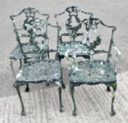 A set of four green painted pierce metal garden chairs,