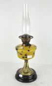 An early 20th century table lamp with a coloured glass reservoir, 58.