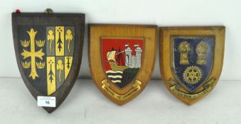 Three wooden crest plaques,