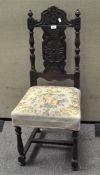 A late 19th/early 20th century carved oak chair, with embroidered seat,